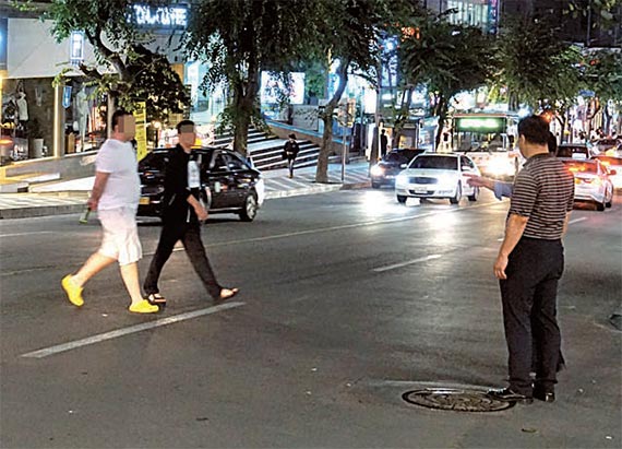 지난 22일 술에 취한 중국인 2명이 제주 바오젠거리 앞 도로를 무단횡단하고 있다. [제주=최충일 기자], [사진 제주서부경찰서]