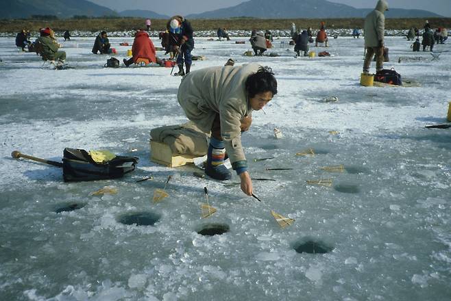 호수 위에서 얼음낚시를 하고 있는 모습. 얼어붙은 호수 아래서도 물고기가 살 수 있는 것은 물의 독특한 물리화학적 특성 덕분이다. [중앙포토]