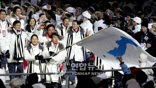 토리노동계올림픽 개막식 남북동시입장 제20회 토리노동계올림픽 개막식이 열린 11일 이탈리아 토리노 올림픽 스타디움에 한반도기를 든 남측 이보라(왼쪽), 북측 한정인 기수 등 우리 선수단이 입장하고 있다.  2006.2.11  (토리노=연합뉴스) zjin@yna.co.kr