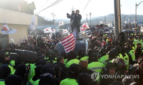 [올림픽] 묵호항에 모인 보수단체 (동해=연합뉴스) 김동민 기자 = 평창동계올림픽을 계기로 강릉과 서울에서 공연할 북한 예술단 본진을 태운 만경봉 92호가 6일 오후 강원도 동해시 묵호항 입항을 앞두고 묵호항연안여객선터미널 앞에서 경찰과 보수단체 회원들이 몸싸움하고 있다.       image@yna.co.kr
