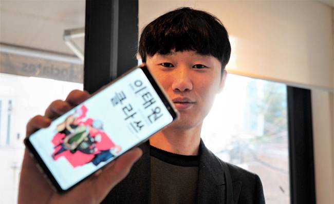 지난 9일 서울시 용산구 필름카페 브라다나에서 만난 작가 광진이 스마트폰에 자신의 히트작 `이태원 클라쓰`를 띄워 보여주고 있다. / 양유창 기자