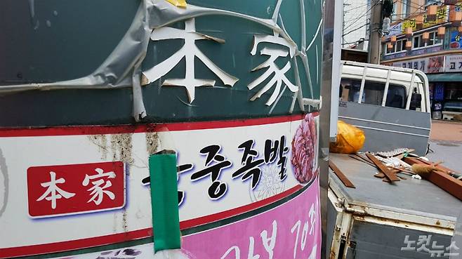 12일 오후 서울 종로구 체부동 궁중족발이 있던 상가. 간판은 떨어지고 창문 유리는 깨져 있었으며 점포 앞은 1t 트럭 한 대가 가로막고 있었다.  곳곳에는 출입금지 경고문과 호소문 등이 덕지덕지 붙어 있었다. (사진=김광일 기자)