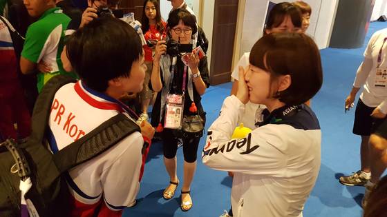 28일 열린 자카르타 팔렘방 아시안게임 탁구 여자 단체전에서 대화를 나누는 북한의 김송이(왼쪽)와 한국의 서효원(오른쪽). 자카르타=김지한 기자