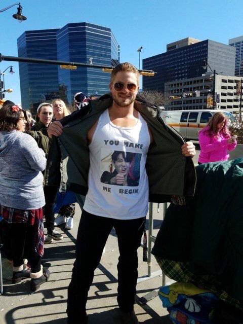 방탄소년단 콘서트를 보러 온 한 외국인 팬이 점퍼 안에 입은 정국 얼굴이 담긴 티셔츠를&nbsp;펼쳐 보이고 있다.