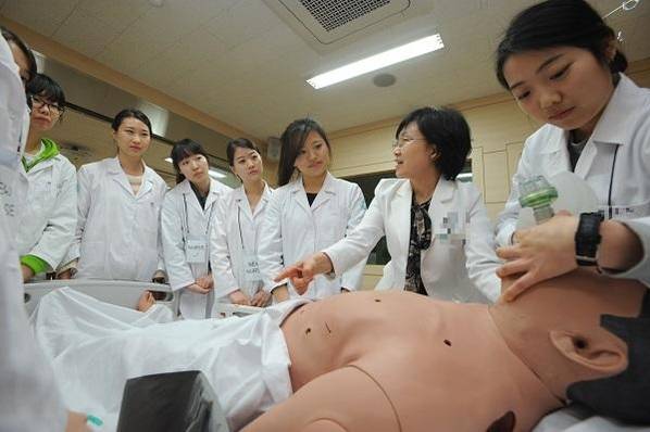 한 대학 간호학과 교수와 학생들이 실습용 마네킹을 이용해 심폐소생술 실습을 하고 있다./ 조선일보 DB