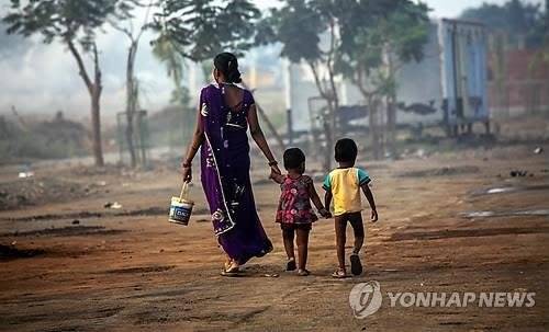 아이들을 데리고 볼일을 보러 가는 인도여성. [EPA=연합뉴스]