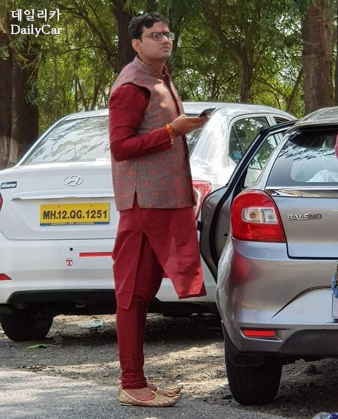 거리에서 본 스마트 폰을 든 전통의상의 인도 남성