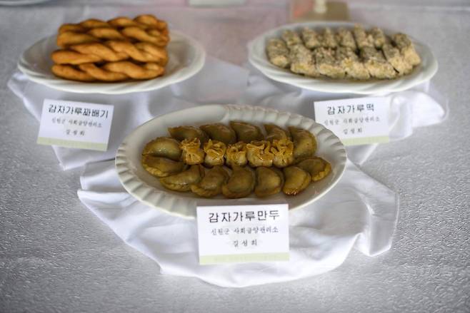 13일 평양에서 열린 북한 전국요리대회에 출품된 감자가루로 만든 요리. 왼쪽부터 시계방향으로 감자가루꽈배기,감자가루떡,감자가루만두.[AFP=연합뉴스]