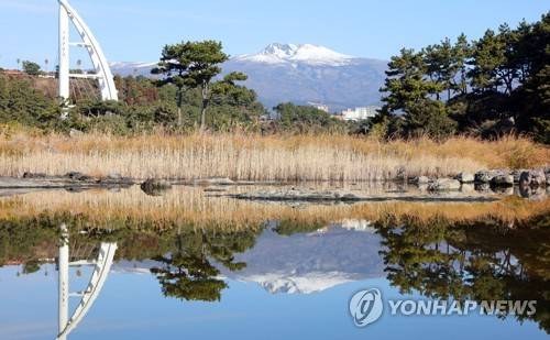 바위 웅덩이에 비친 한라산 (제주=연합뉴스) 제주 서귀포시 새섬공원 내 바위 웅덩이에 눈 쌓인 한라산 백록담과 새로운 인연을 만들어 간다는 다리인 새연교의 주탑 모습이 오롯이 투영돼 신비로움을 자아내고 있다. [연합뉴스 자료사진]