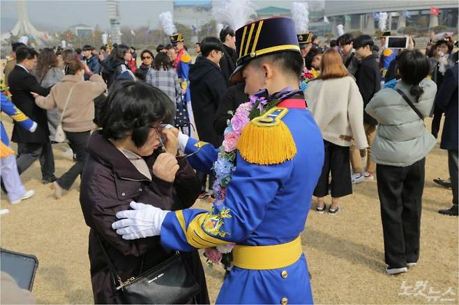 한 육사생도가 입학식에 참석해 눈물을 흘리고 있는 어머니의 눈물으 닦아주고 있다.