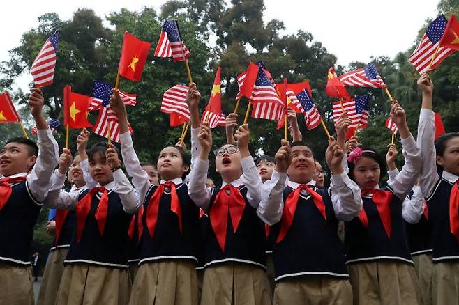 베트남 수도 하노이 거리에서 한 중학교 학생들이 2월27일 미국과 베트남, 북한 국기를 흔들고 있다. 로이터연합뉴스