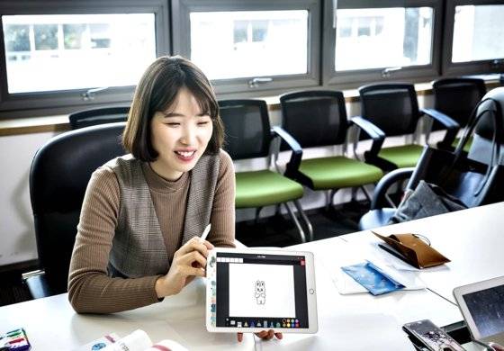 정선화 작가가 아이패드에 자신의 캐릭터 오덕토끼를 그려 보이고 있다.