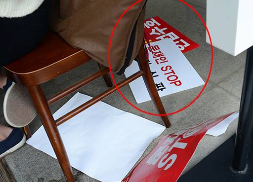 지난 27일 오후 서울 세종문화회관 앞에서 열린 자유한국당 집회에 사용된 각종 행사용품들이 광화문 인근 카페 바닥에도 나뒹굴고 있다.