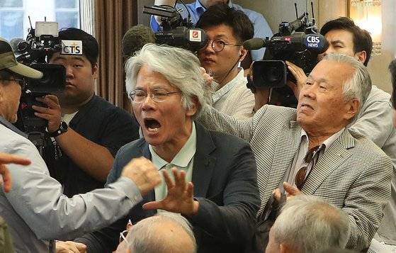 전광훈 목사가 11일 서울 세종로 프레스센터에서 기자회견을 열고 '문재인 대통령 하야'를 촉구했다. 한 참석자가 항의하다 머리끄덩이를 잡혀 쫓겨나고 있다. 오종택 기자