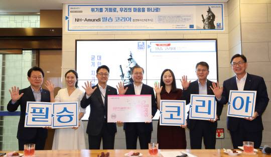 文대통령, 취임후 첫 펀드 투자 : 문재인 대통령이 26일 오전 서울 중구 NH농협은행 본점에서 ‘애국펀드’라고 불리는 ‘필승코리아 펀드’에 가입한 뒤 김광수(왼쪽) 농협금융지주회장, 이대훈(오른쪽) 농협은행장 등과 함께 손가락을 펼쳐 보이며 기념사진을 찍고 있다.  연합뉴스