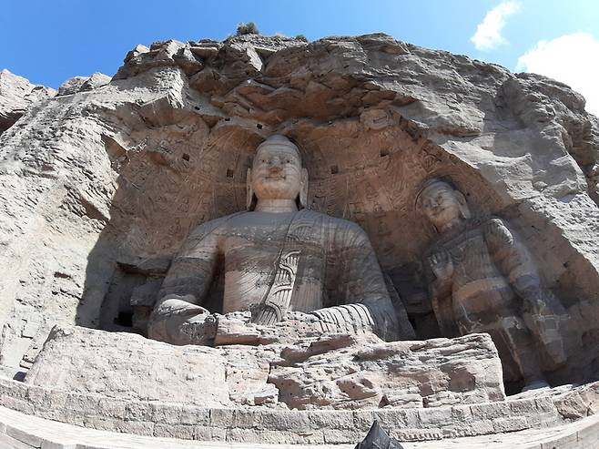 윈강석굴을 대표하는 석불로 꼽히는 20굴 본존상. 윈강석굴은 황제가 곧 부처라는 국가불교 사상을 기반으로 만들어졌다. 이 대불의 모델이 된 북위 황제가 누구인지는 학계의 오랜 논란거리다.