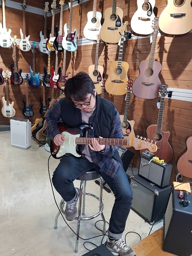 박주원이 기타네트 매장에서 펜더 빈테라 스트라토캐스터를 시연하고 있다.