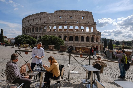 8일(현지시간) 이탈리아 로마의 관광명소 콜로세움 앞. 관광객들이 레스토랑 야외 테이블에서 관광을 즐기고 있다. [EPA=연합뉴스]