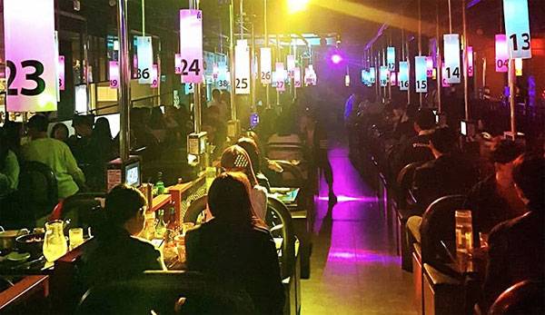 어두운 실내에 음악을 틀어놓고 손님 간 합석을 유도하는 `헌팅 술집` 내부. [SNS 캡처]