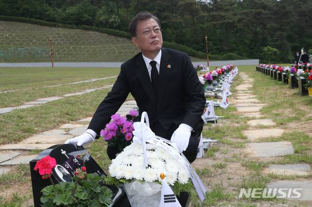 [광주=뉴시스]박영태 기자 = 문재인 대통령이 제40주년 5·18 민주화운동 기념일인 18일 광주 북구 5·18 민주묘지 제2묘역에서 고(故) 이연 씨 묘를 참배하고 있다. 고인은 전남대 1학년에 재학 중이던 1980년 5월 27일 YMCA 회관에서 계엄군과 총격전 중 체포되어 전신 구타를 당했다. 2020.05.18.since1999@newsis.com