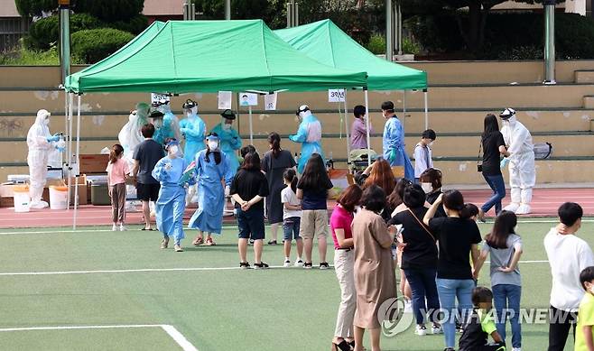 차례 기다리는 학생들 (대전=연합뉴스) 김준범 기자 = 2일 오전 대전시 동구 천동 대전천동초등학교에서 학부모와 학생이 신종 코로나바이러스 감염증(코로나19) 검사 차례를 기다리고 있다. 2020.7.2 psykims@yna.co.kr