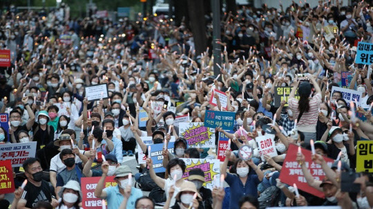 25일 서울 예금보험공사 앞에서 열린 '소급적용 남발하는 부동산 규제 정책 반대, 전국민 조세 저항운동 촛불집회' 참가자들이 촛불을 들고 있다.<연합뉴스>