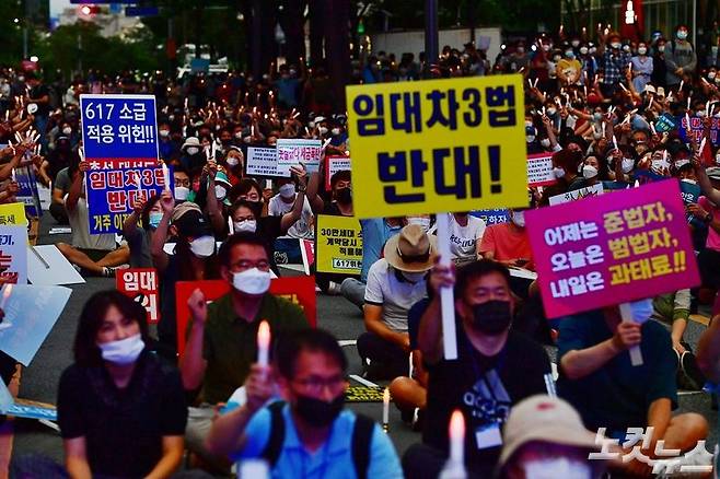 지난 25일 오후 서울 중구 예금보험공사 앞에서 열린 '소급적용 남발하는 부동산 규제 정책 반대, 전국민 조세 저항운동 촛불집회' 참석자들이 피켓과 촛불을 들고 구호를 외치고 있다. (사진=윤창원 기자)