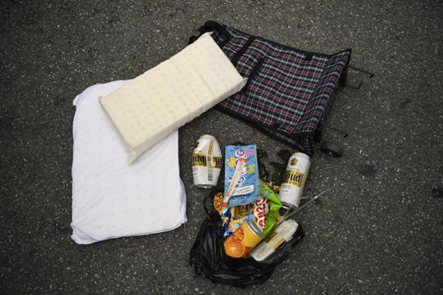 재활용이 되지 않는 라텍스 소재의 베개와 바퀴 달린 여행용 가방. 종량제 봉투에 넣거나, 신고필증을 붙여 버려야만 하지만, 헌옷수거함에 넣어놓는 경우가 많다. 공원 인근 헌옷수거함에서 나온 검은 봉지 안엔 맥주캔과 과자봉지 등 쓰레기가 가득하다.