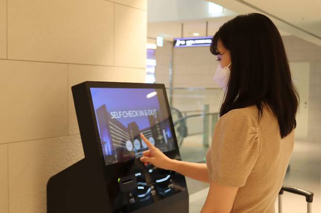 롯데리조트속초 고객이 지하주차장 인근에 설치된 키오스크를 통해 객실 체크인을 하고 있다.