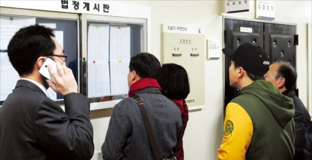 경매 투자자들이 서울동부지방법원 게시판에 나온 매물 정보를 살펴보고 있다. 한경DB
