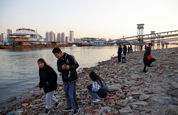 지난해 말 코로나19 바이러스가 최초로 보고됐던 중국 후베이성 우한에서 31일 시민들이 마스크 없이 강변을 걷고 있다.로이터뉴스1
