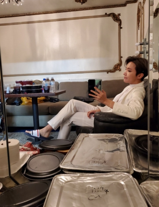 Another photo featured J-Hope sitting in a white suit in the atmosphere, taking a mirror selfie, and J-Hope posing as if he were taking a picture with his face on Camera.