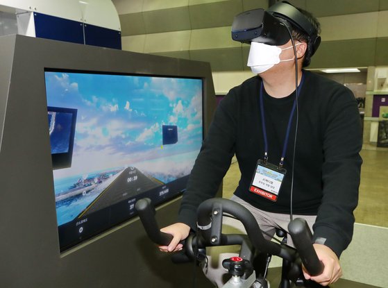 지난달 2일 오후 서울 강남구 코엑스에서 열린 '2020 대한민국 소프트웨어대전' 한 부스에서 관계자가 VR(가상현실) 기술을 활용한 자전거 여행 콘텐츠를 시연하고 있다. 연합뉴스
