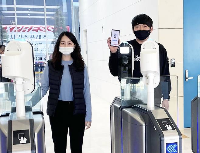 ▲ 대구은행 혁신센터 직원들이 블록체인 기반 분산신원증명(DID) 기술을 적용한 모바일 사원증으로 출입 인증을 받고 있다. DGB대구은행 제공.