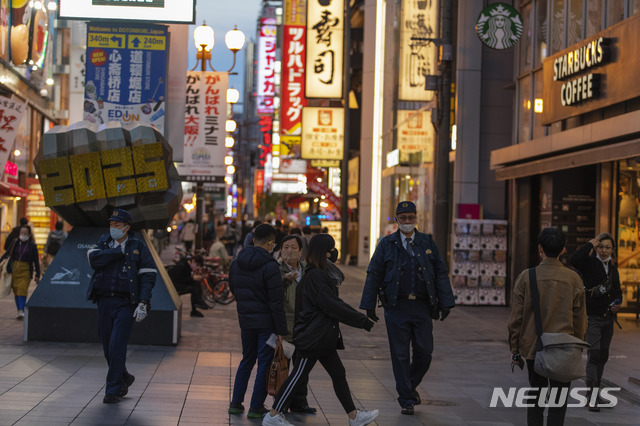 [오사카=AP/뉴시스] 지난해 11월 30일 일본 오사카에서 관광객들에게 인기가 많은 거리를 마스크를 착용한 경찰관들이 순찰하고 있다. 2020.12.03.