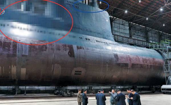김정은 북한 국무위원장이 2019년 7월 당시 건조된 신형 잠수함을 둘러보는 모습. 조선중앙통신은 이 사진을 보도하면서 SLBM 발사관으로 추정되는 부분(붉은 원)과, 함교탑 부분(파란 원)을 각각 모자이크 처리했다. 3000t급 로미오급 개량형 잠수함이 북한 핵잠수함으로 가는 징검다리가 될 것으로 추정된다. 평양=조선중앙통신 연합뉴스