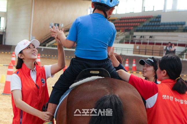 한국마사회 홍보대사 권소현(왼쪽)이 재활승마 현장에서 자원봉사를 하고 있다.&nbsp; 제공 | 한국마사회