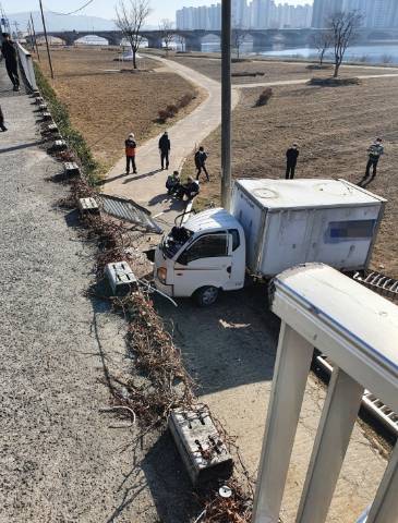 14일 오전 10시 42분쯤 울산 중구 학성동 가구사거리 인근에서 트럭이  태화강 둔치로 떨어졌다. 울산소방본부 제공