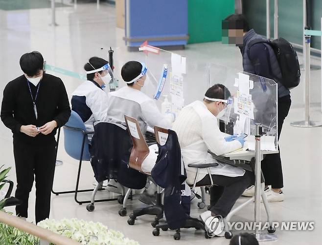 안정세 접어드는 3차 대유행 신종 코로나바이러스감염증(코로나19) 확산세가 잦아드는 가운데 지난 14일 오전 인천국제공항 1터미널에서 해외입국자가 방역관계자로부터 안내를 받고 있다. [연합뉴스 자료사진]