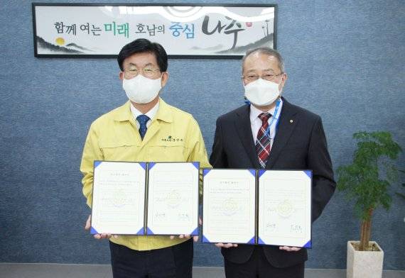 강인규 나주시장(사진 왼쪽)과 윤성철 나주신용협동조합 이사장이 20일 '옛 나주극장 문화재생 업무협력 협약'을 체결한 뒤 기념촬영을 하고 있다.사진=나주시 제공