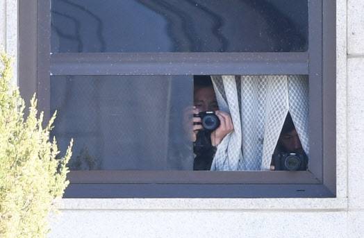 지난달 4일 오전 판문점 북측 판문각 창문 틈으로  북한군들이  카메라로 남측지역을 찍고 있다(판문점=사진공동취재단).