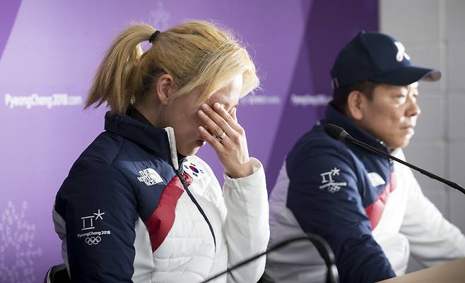 김보름이 2018년 2월 20일 기자회견에서 전날 있었던 평창올림픽 팀추월 경기에 대해 이야기하며 손으로 눈물을 훔치고 있다. 뒤는 백철기 감독. /김지호 기자