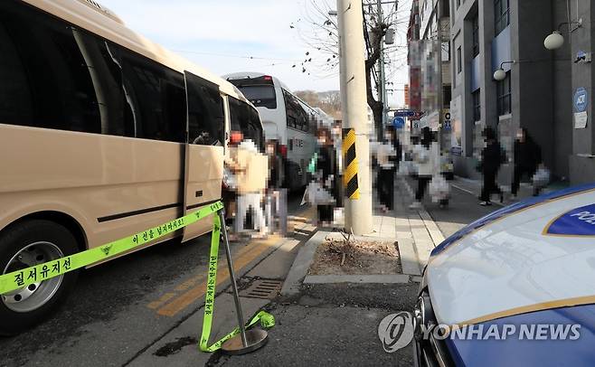 차량으로 이동하는 IEM국제학교 확진자들 25일 오후 대전시 중구 대흥동 IEM국제학교에서 신종 코로나바이러스 감염증(코로나19) 확진자들이 치료센터로 이동하기 위해 차량에 탑승하는 모습. 비인가 종교교육시설인 IEM국제학교에서는 133명이 확진됐다. [연합뉴스 자료사진]