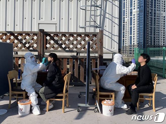 27일 부산 해운대구청 옥상에 마련된 찾아가는 임시선별검사소에서 직원들이 코로나19 진단 검사를 받고 있다.(부산 해운대구 제공) © 뉴스1