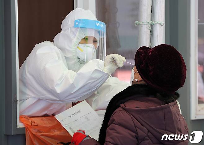 의료진이 29일 오전 서울 중구 서울역 광장에 마련된 코로나19 임시선별진료소에서 시민의 검체검사를 하고 있다. 2021.1.29/뉴스1 © News1 박세연 기자