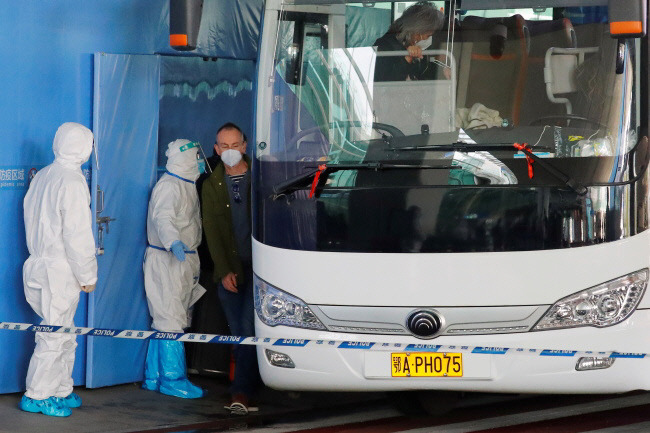 세계보건기구(WHO) 국제조사팀이 지난 14일 코로나19가 처음 발견된 중국 우한의 텐허 국제공항에 도착해 버스에 오르고 있다. 사진 로이터·연합뉴스