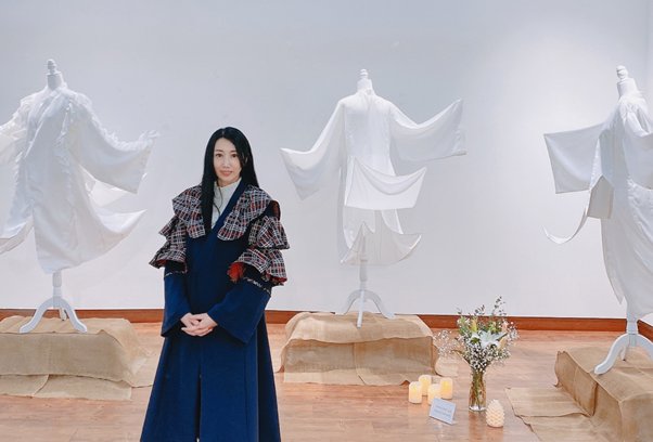 작품 앞에서 포즈를 취하고 있는 김주연 디자이너