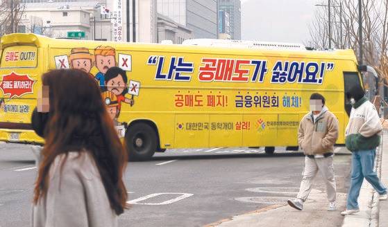 개인투자자 모임인 한국주식투자연합회(한투연)가 1일 오후 서울 세종로에서 공매도 반대 운동을 위해 '공매도 폐지', '금융위원회 해체' 등의 문구를 부착한 버스를 운행하고 있다. 연합뉴스