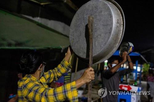 양곤 시민이 쿠데타에 대한 항의 표시로 양철 쟁반을 두드리고 있다. 2021.2.2 [AFP=연합뉴스]