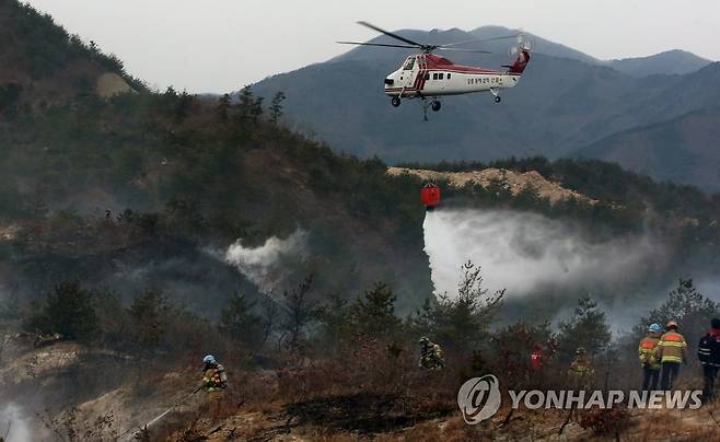 동해안 봄철 산불 비상 (강릉=연합뉴스) 이해용 기자 = 16일 오후 진화 헬기가 강원 강릉시 옥계면 산계리에서 발생한 산불을 끄고 있다. 2021.2.16 dmz@yna.co.kr